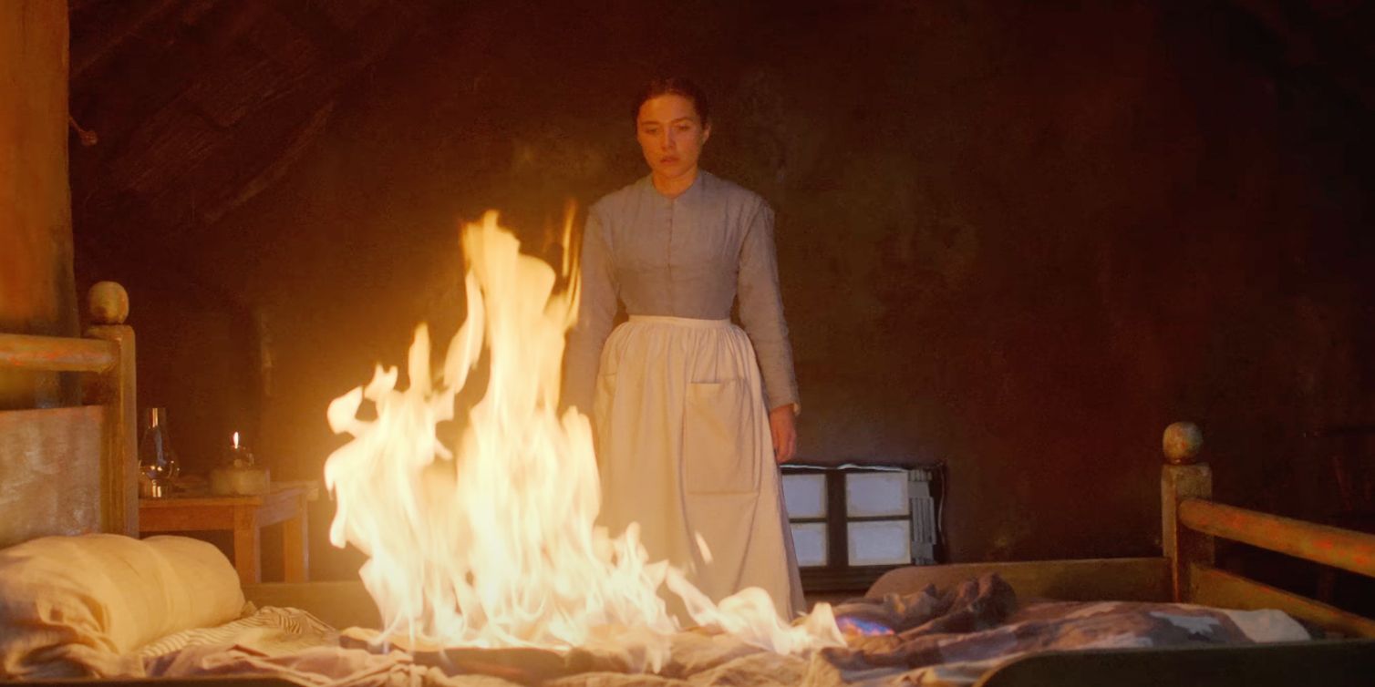 Florence Pugh looking at a burning bed in The Wonder