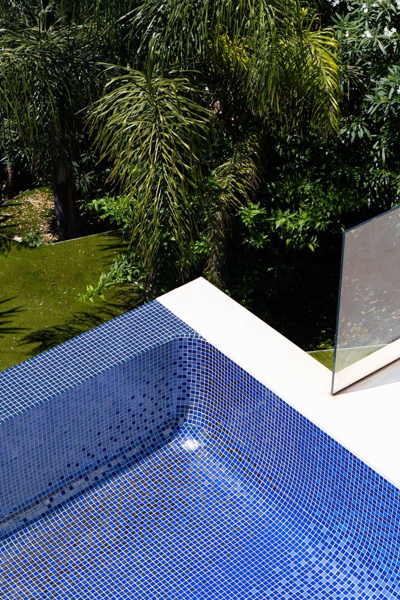 looking down into empty swimming pool with colorful mosaic tiles