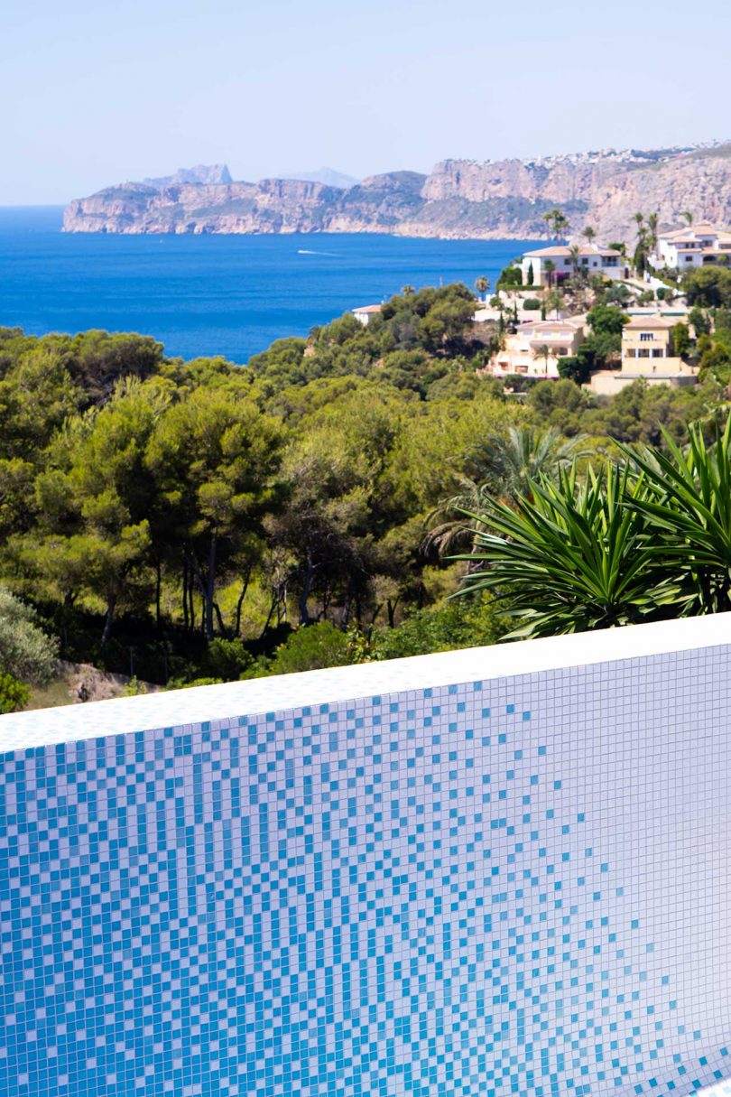 looking down into empty swimming pool with colorful mosaic tiles