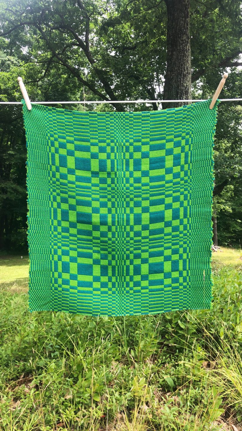 green textile throw blanket