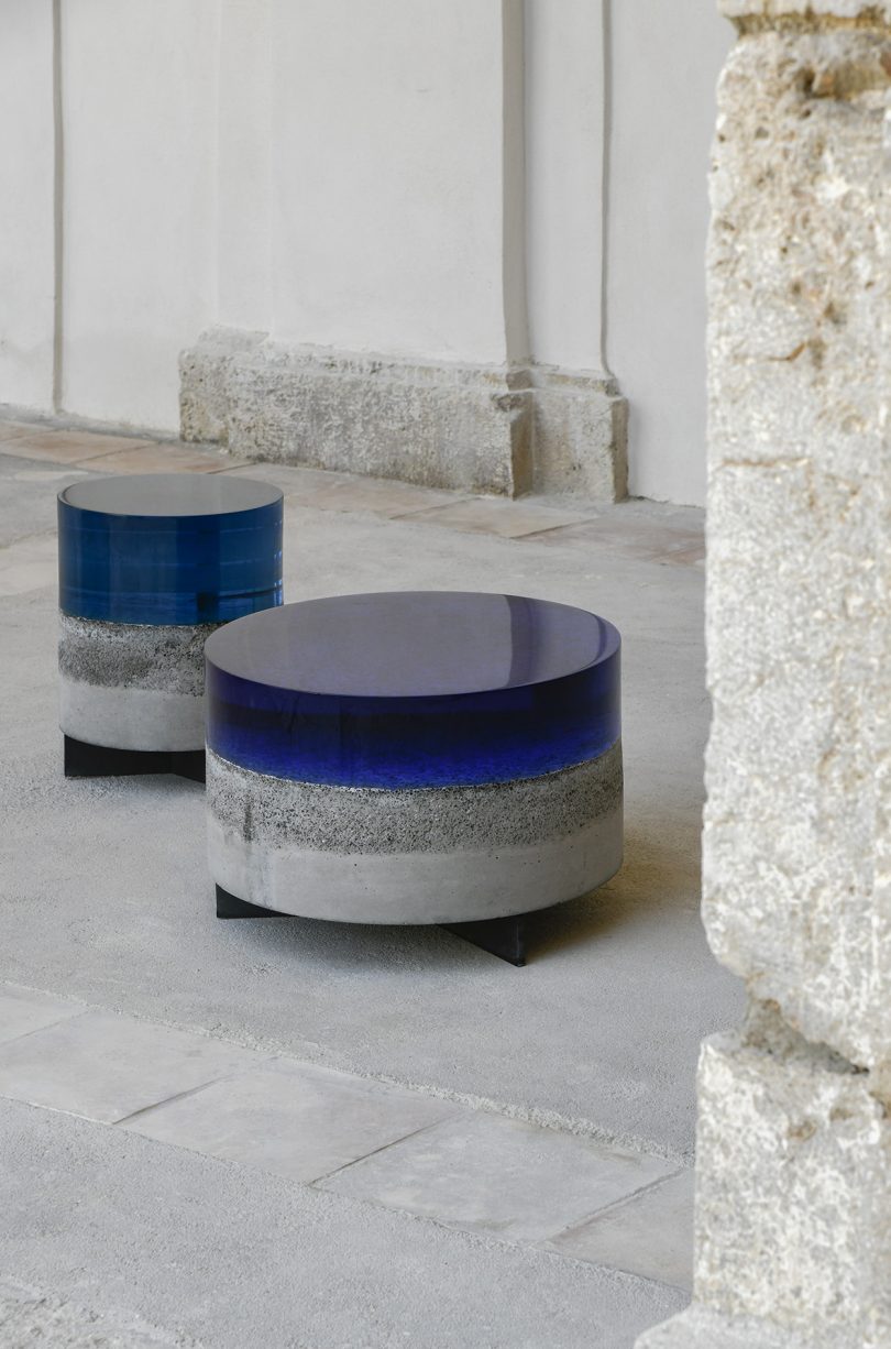 two concrete and resin tables in interior space