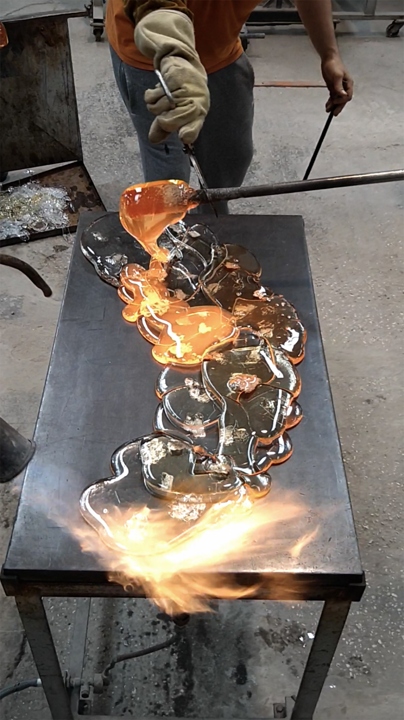 molten glass being shaped by tools