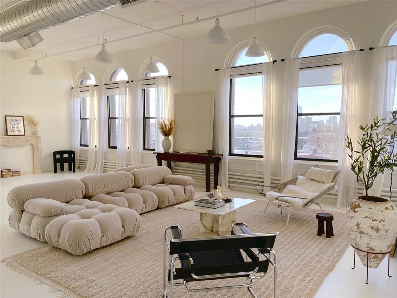 large open loft with large windows and lots of light colors