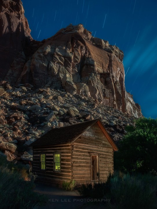 night photography cabin light and rocky mountain