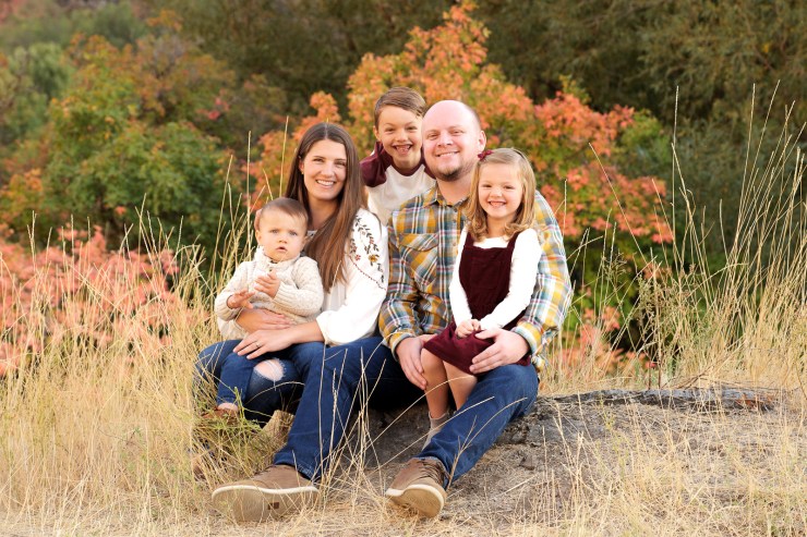 family portrait with fall leaves in background
