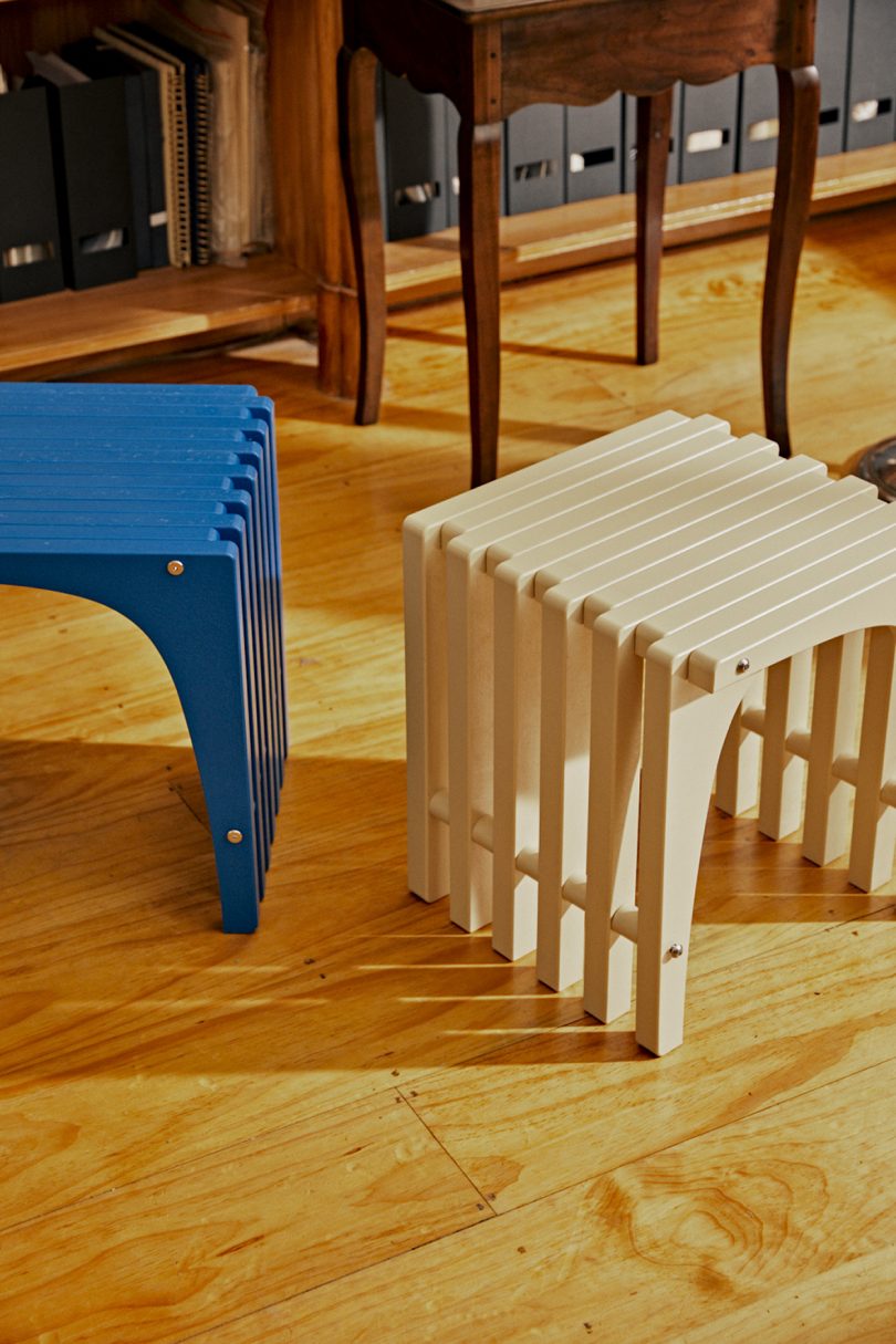 blue stool and cream stool in styled interior space