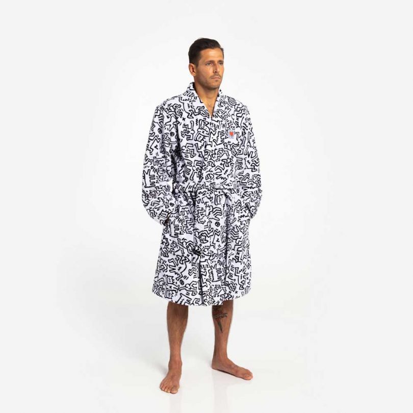 man in black and white robe with keith haring artwork