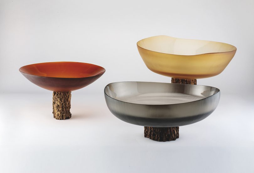 three bowls/vessels in muted hues on white background