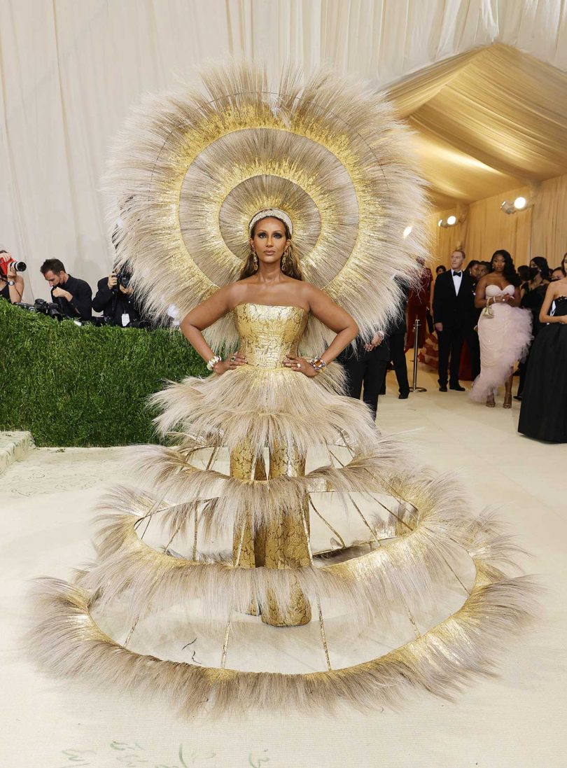model Iman dressed in gold and feathers at Met Gala