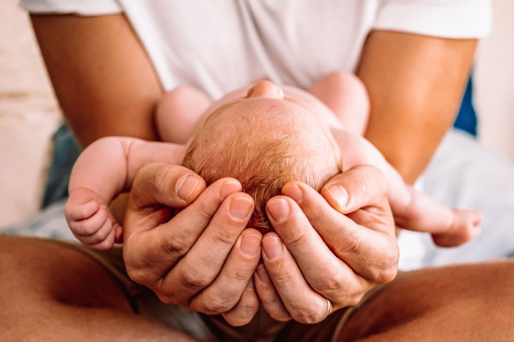 family baby in father's hands