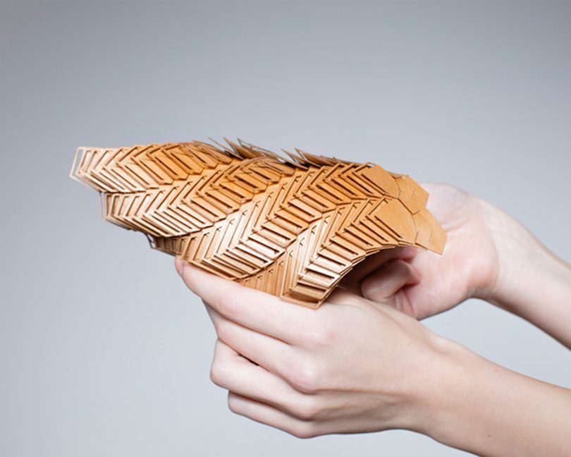 brown modular material being manipulated by two hands