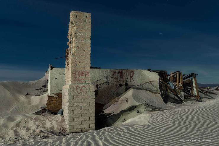 House buried in sand. California desert.
