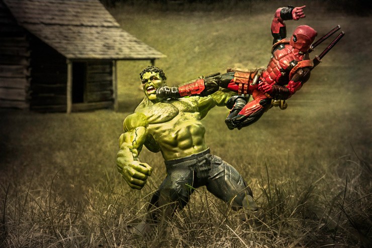 The Hulk takes a flying kick from Deadpool in front of a real life cabin.