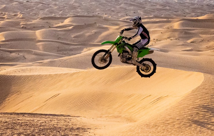 dirt bike photo jumping the desert dunes