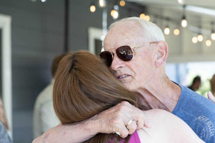 Grandpa hugging his daughter