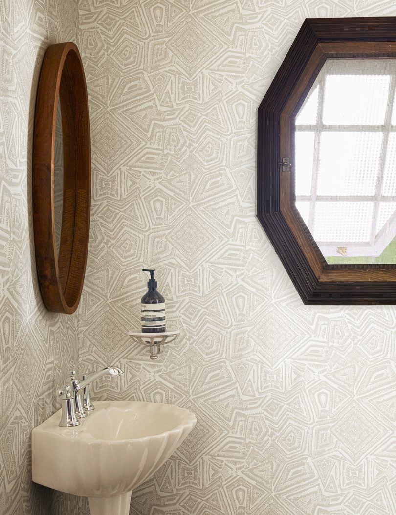 light tan patterned wallpaper in bath