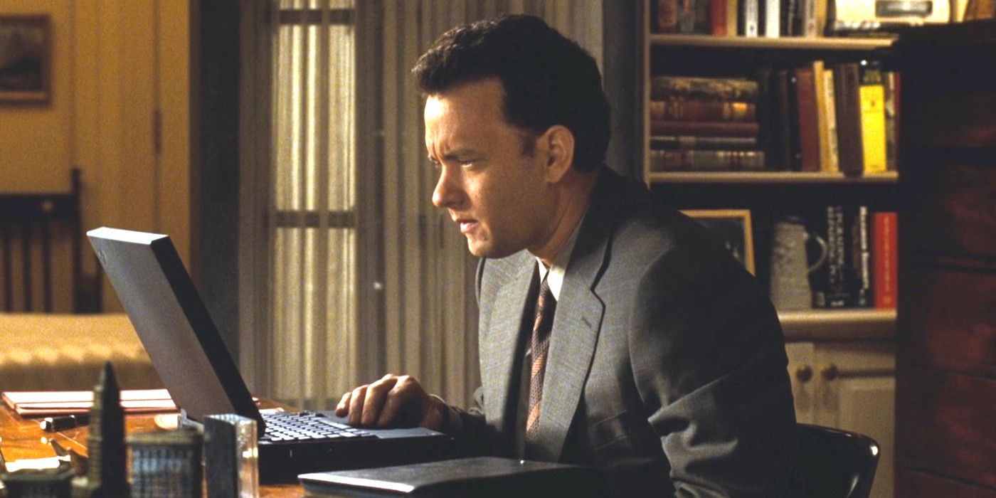 Tom Hanks in You've Got Mail sitting slightly hunched forward squinting his eyes at a laptop screen