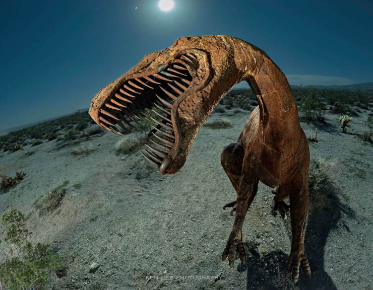 Night photo of dinosaur sculpture