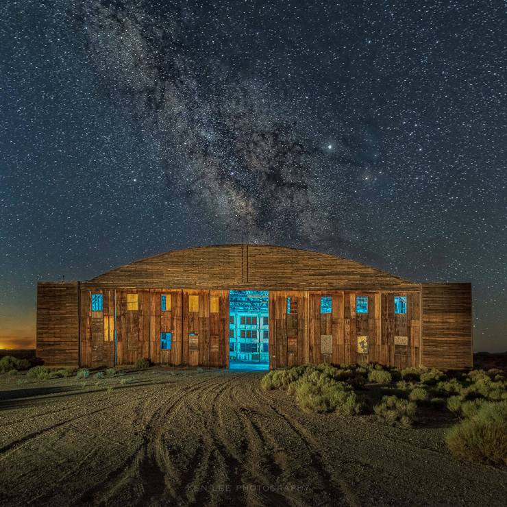 Milky Way over abandoned wooden hangar