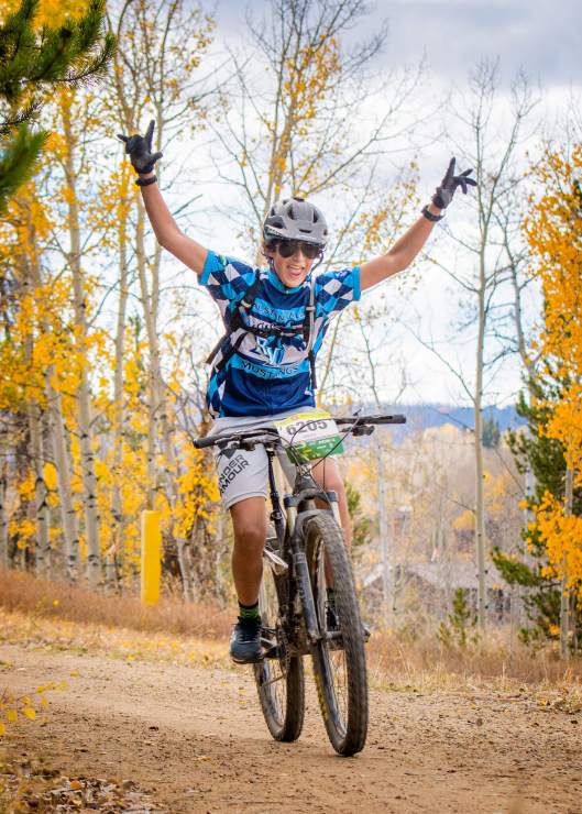 mountain bike racer celebrating with hands in the air