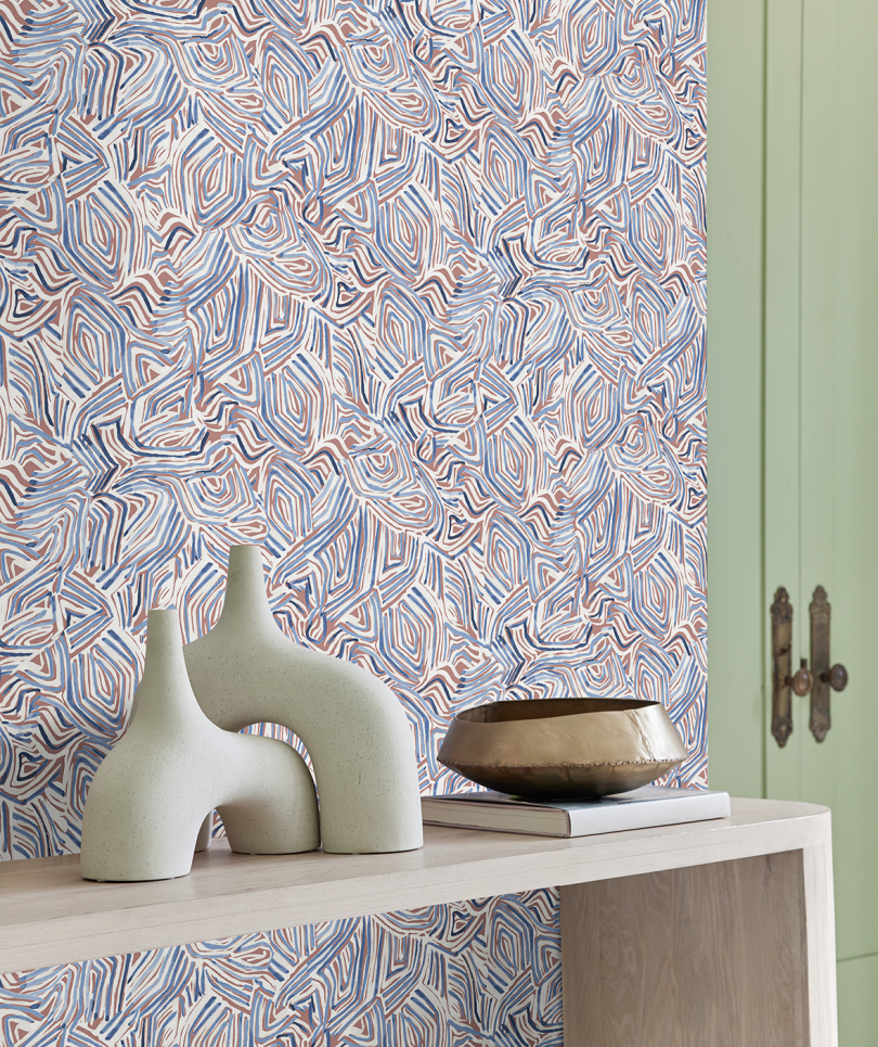 blue and grey patterned wallpaper in entry way