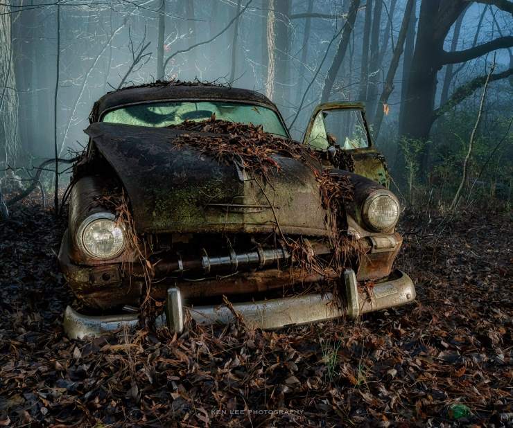 Vintage automobile at night, light painting. Fog.