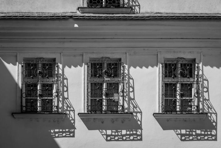 Windows with iron balcony shadows