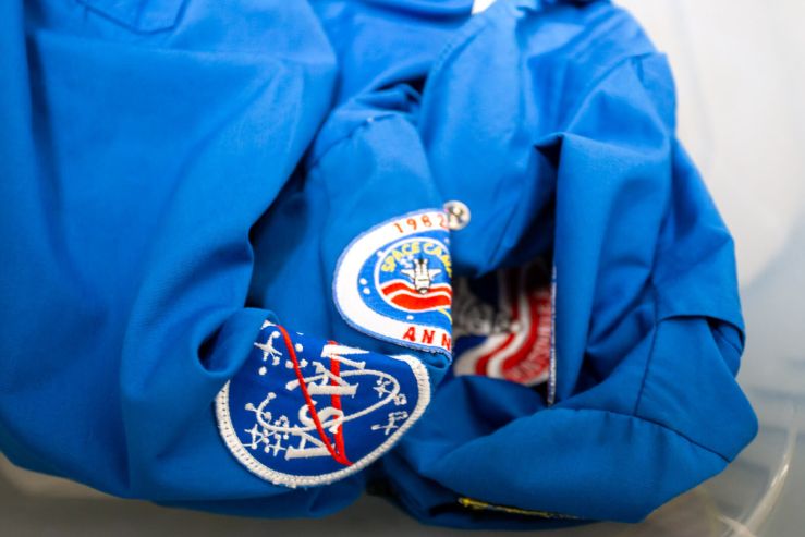 NASA patches on blue jumpsuit