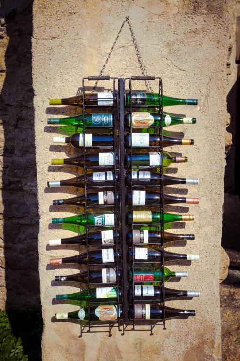 wine bottles on outside wall of wine bar Durnstein