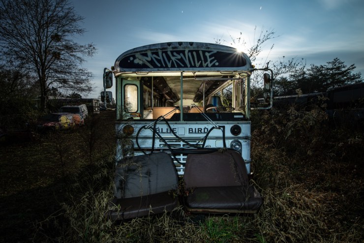 Photo by Tim Little. Night photo with light painting, Schoolbus Graveyard, rural Georgia.