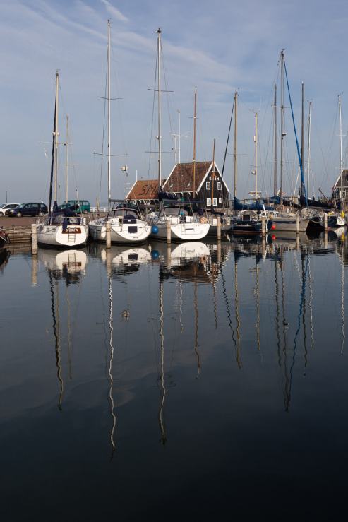 Sailing boats reflected in the harbor of Marken