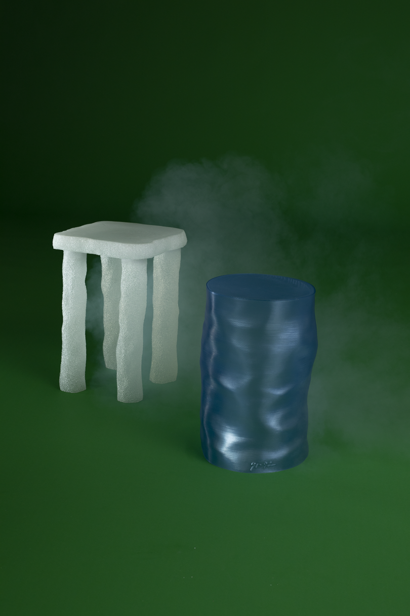 white side table and blue stool on green background