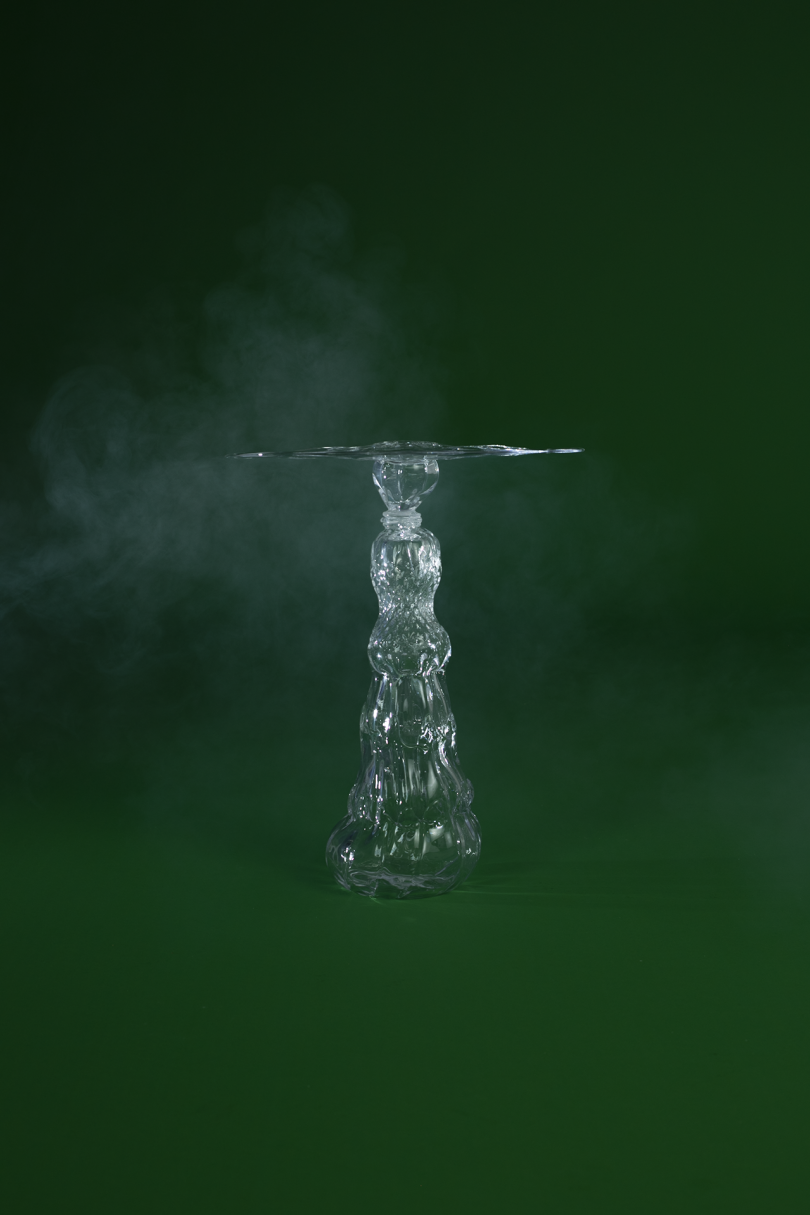 glass side table on dark green background