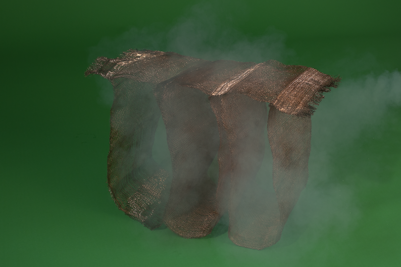 woven object on dark green background with white smoke