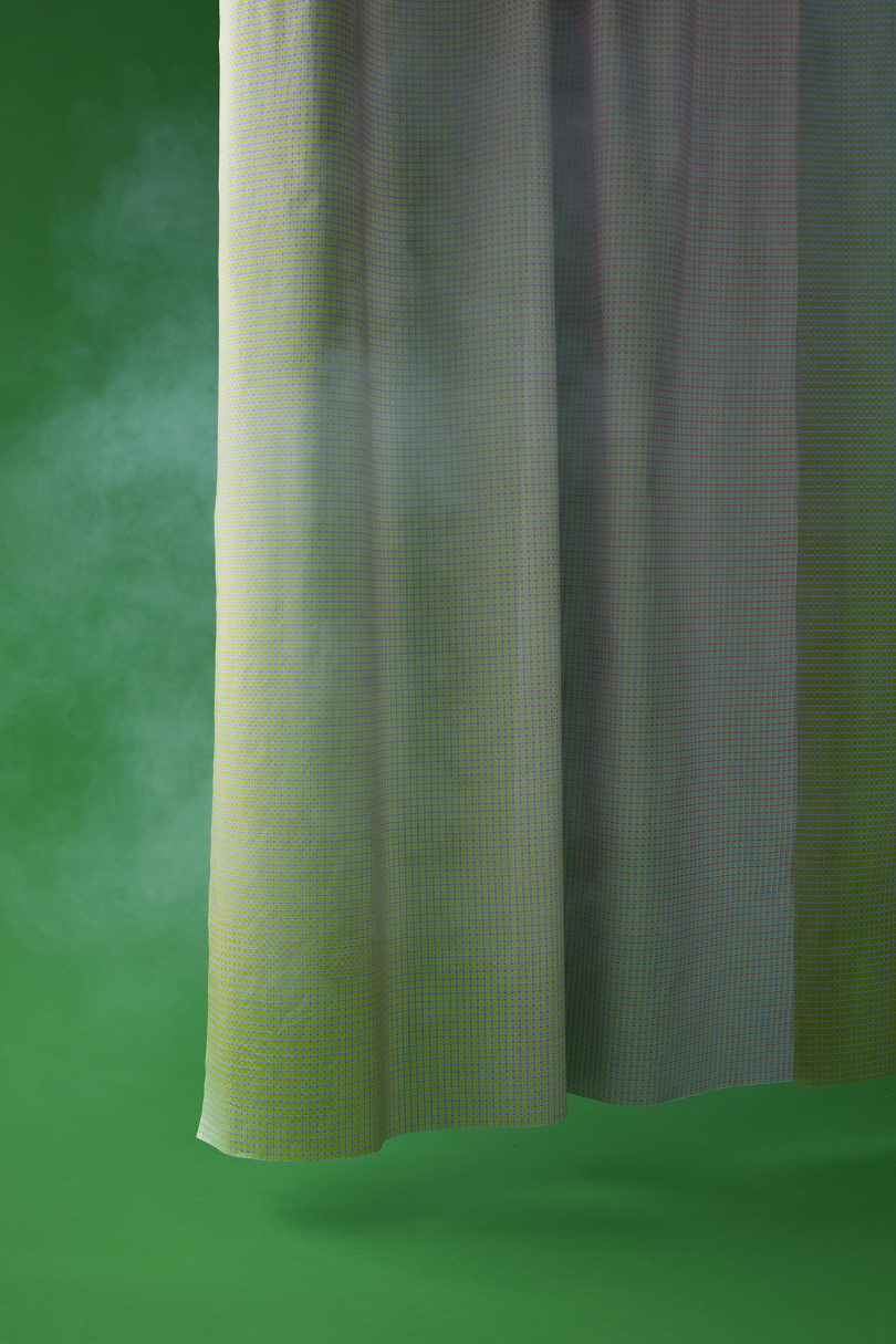 grey curtain on dark green background with white smoke