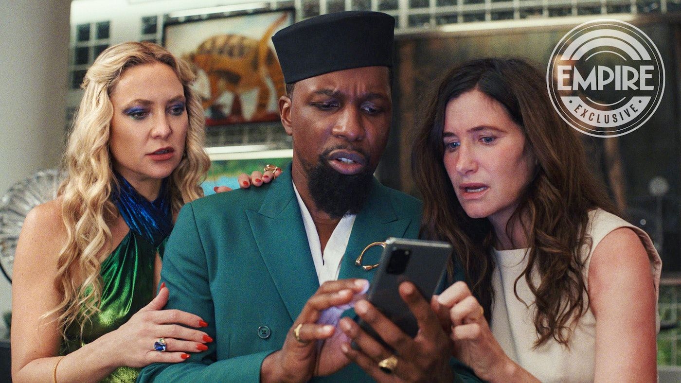 Kate Hudson, Leslie Odom Jr. and Kathryn Hahn in Knives Out 2 captivated by a cell phone.