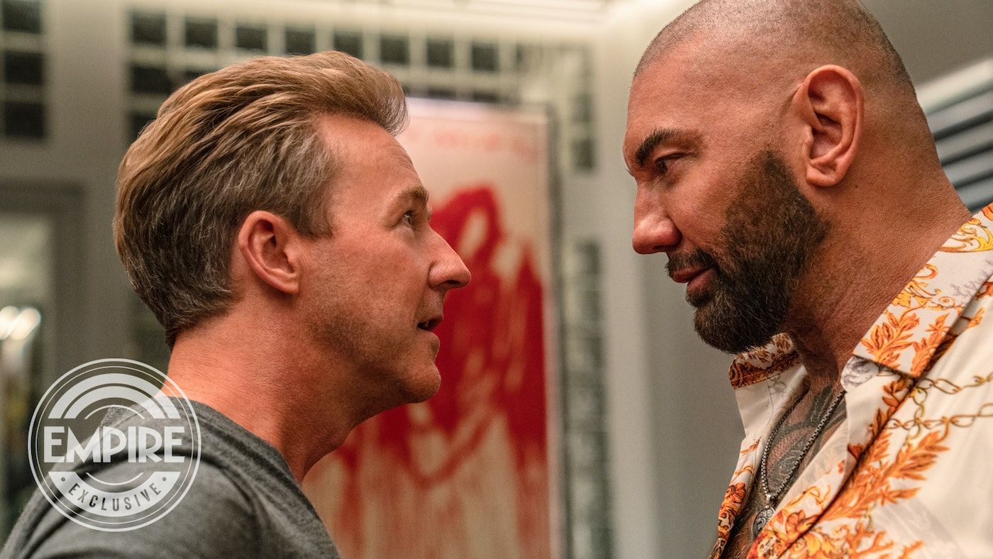Ed Norton and Dave Bautista in Knives Out 2 staring each other down intensely